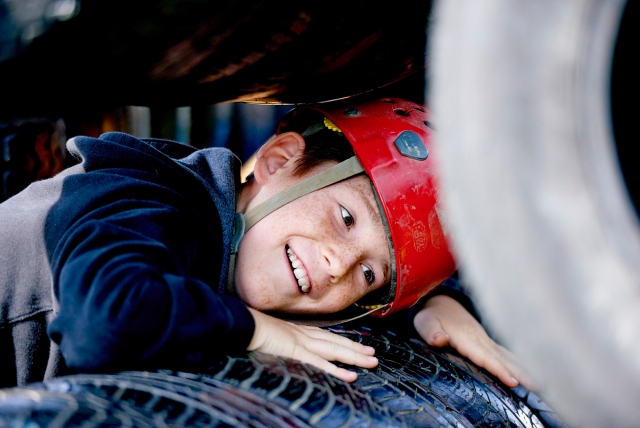 Happy boy lying on a wheel
